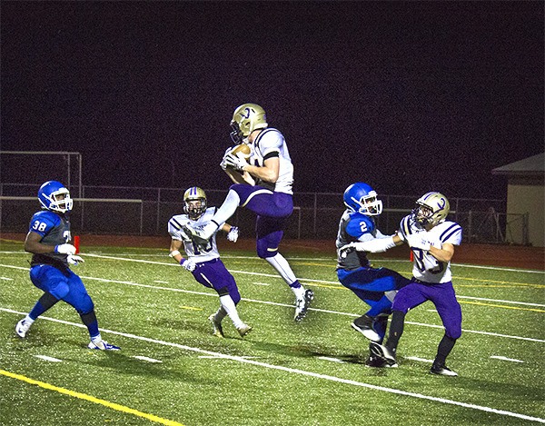North Kitsap senior running back Sean Crowell leaps up to intercept a pass from Olympic seconds before the end of the first half