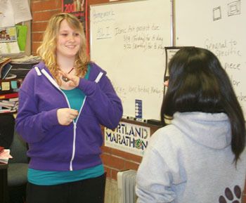 Brandi Oglesby signs with another student during their American Sign Language class at South Kitsap High School.