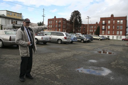 Maj. Jim Baker points to the parking lot behind the Bremerton Salvation Army where he plans to host a tent city for the homeless. Tents would be placed on top of wooden pallets to avoid water seeping in from the bottom.