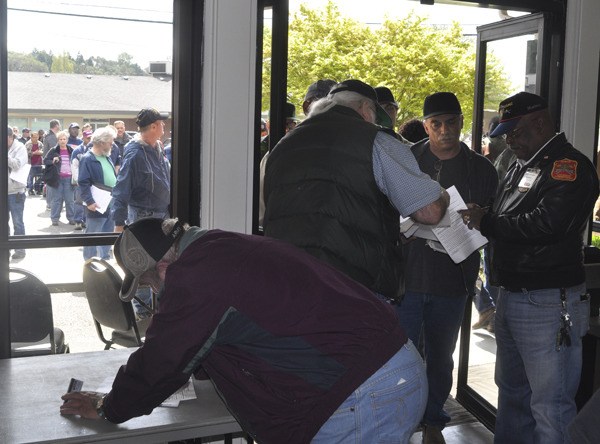 Veterans line up at the Sheridan Community Center in Bremerton Saturday morning to enter the biannual Stand Down which provides access to services and benefits to those in need as well as a central gathering point for area veterans.