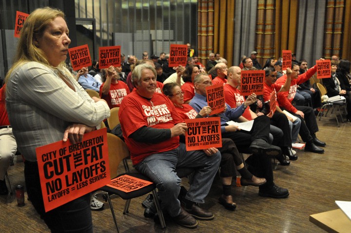 Greg Skinner/staff photo Members of “Cut the Fat” protest proposed city layoffs during Bremerton City Council deliberations on the 2012 budget. The council voted Dec. 7 to charge a $20 tax on cars to fund some streets’ employees.