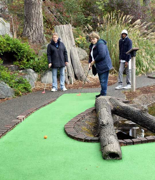 Local businesspeople and community leaders participate in the 15th annual Linda Joyce YWCA Charity Putt Putt event.