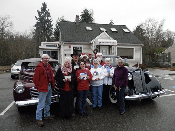The Olympic Vintage Auto Club presented checks to four local food banks on Dec. 17.