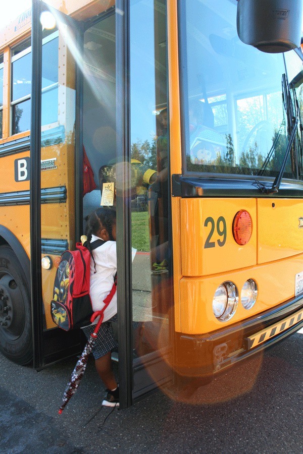 An Armin Jahr Elementary kindergarten student boards the afternoon bus to go home from school. Kindergarten students are put in the front seats in order to not miss their stops.