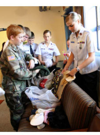 Civil Air Patrol Peninsula Composite Squadron 051 cadets sort through donations for their care package program Oct. 5 at Bremerton Airport. CAP is collecting winter clothing and food items for troops and contractors in Afghanistan and the Afghan people.