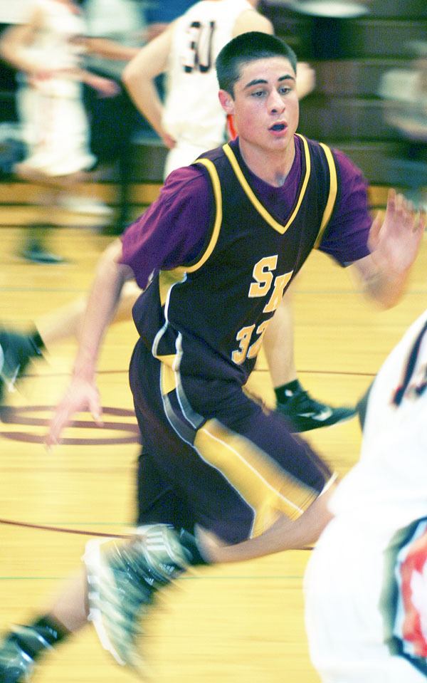 SK’s Nars Martinez races to keep up with a Cougar fast break in the Wolves’ 57-52 win
