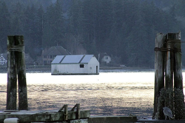 John Zetty’s boathouse sits at anchor in Liberty Bay on Dec. 1. DNR is accepting bids to have the boathouse destroyed
