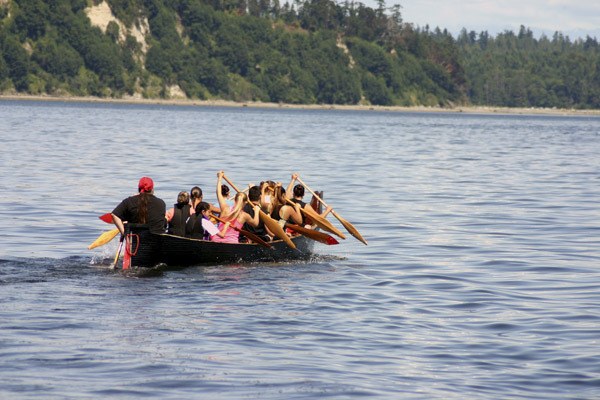 A Suquamish canoe heads out to greet canoes July 21