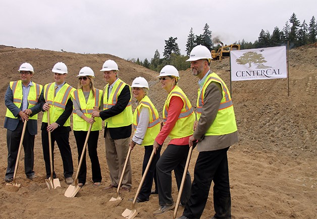 County commissioners and CenterCal workers stand together for a groundbreaking shovel dig at The Trails of Silverdale. Construction will start this fall