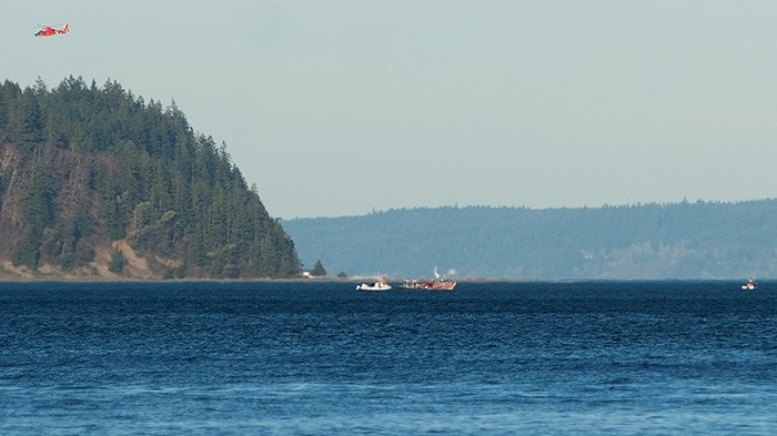 Members of the Coast Guard and Kitsap County Sheriff's Office search for the downed plane on Jan. 26.