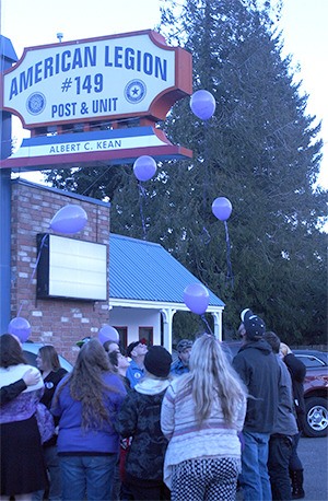 Family members release more than a dozen purple balloons in memory of Amber Lynn Coplin during a Nov. 29 memorial service in Bremerton.