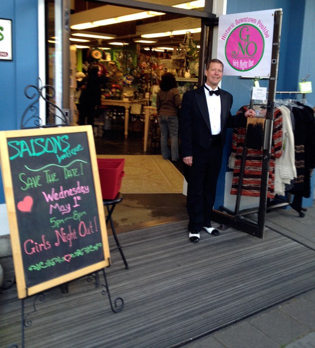 A gentleman holds the door open at Saison's Boutique in Poulsbo during last year's Girls Night Out.