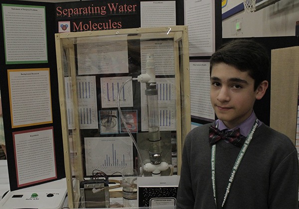 Eighth grader Benjamin Bissell of Cedar Park Christian School in Bothel stands with his project.