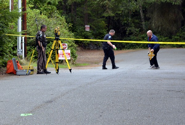 Sheriff's investigators look for possible evidence related to the deaths of a couple in a travel-trailer at Rhododendron Mobile Park south of Poulsbo
