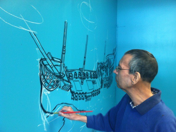 Port Orchard resident Rich Washek paints a mural on a wall. The local muralist is suffering from cancer and a local church is assisting him during his treatment.