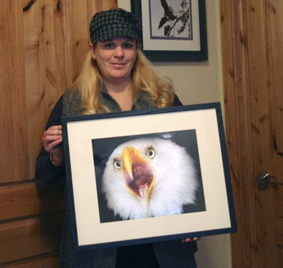 Dena Scott holds the photo she took of a bald eagle. The Bremerton vet plans to take up a full-time career as a wildlife photographer.