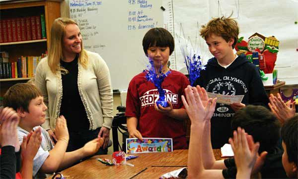 Suquamish Elementary teacher Kristy Dressler presents math awards to Daniel Nguyen