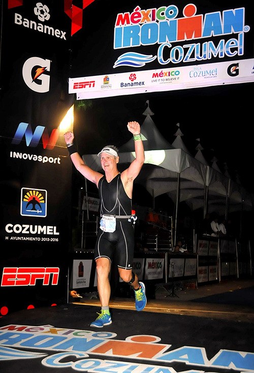 Brian Whelan runs across the finish line in Cozumel on Nov. 29