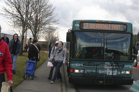 Kitsap Transit riders deboard the bus Monday at the new bus stop on NW Randall Way in Silverdale. Kitsap Transit was forced to move its transfer station off of Kitsap Mall property after mall management declined to renew a lease agreement.