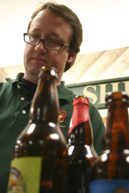Marina Market owner Jonathan Rowe pours some brew during a recent beer tasting.