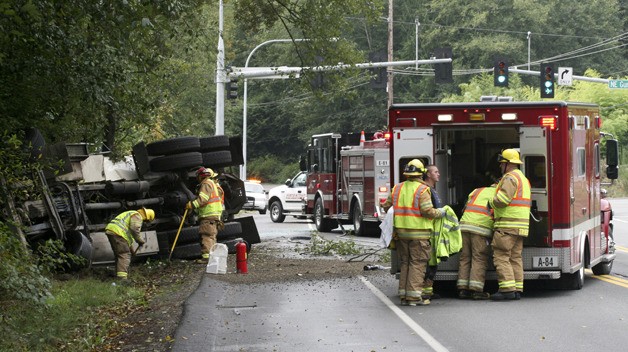 A hydroseed truck rolled over at the intersection of Miller Bay Road and Gunderson Road Friday morning.