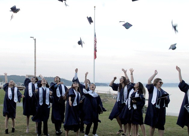 The West Sound Academy Class of 2015 celebrates their graduation with the traditional hat toss after receiving their diplomas May 28.