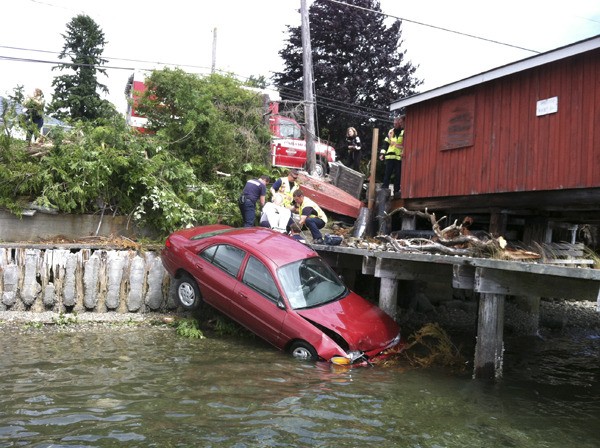 An 80-year-old woman was uninjured after crashing into Liberty Bay Thursday afternoon.