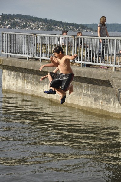 Young swimmers enjoy a summer day by plunging into Sinclair Inlet.