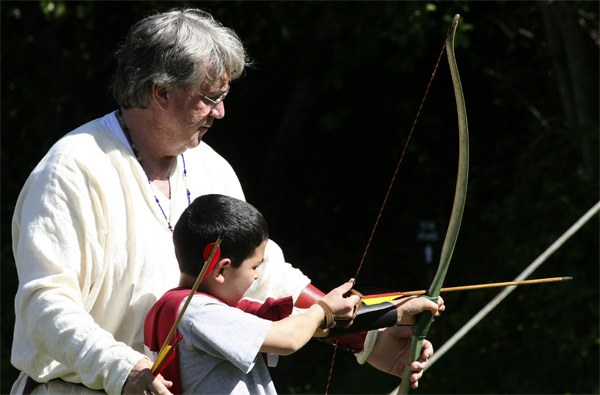 A young archer receives instruction at last year's Medieval Faire in Port Gamble. This year's event runs Saturday 10 a.m. to 5 p.m.; and Sunday