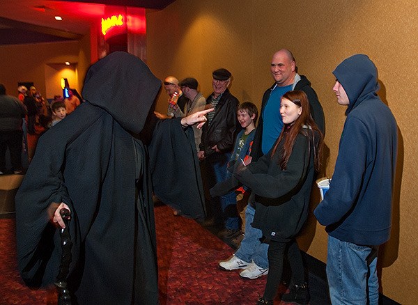 The Emperor (Rob Taylor of Redmond) notifies moviegoers in line that they have been conscripted as Stormtroopers at SEEfilm theater in Bremerton Dec. 19.