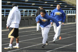 Bremerton’s Keefer Kaselen waits for a handoff from teammate Jarell Flora during practice Tuesday. Both Kaselen and Flora could earn spots on the 4X100-meter relay team