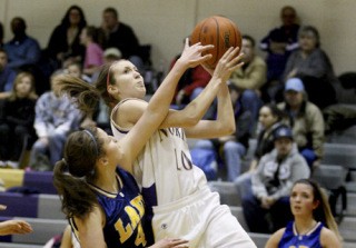 North Kitsap forward Kira Markey goes for a layup for a 2-pointer during home action against the Bremerton Knights.