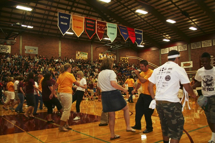 South Kitsap High School staff entertain an assembly for sophomores with a “flash-mob dance” Wednesday morning on the first day of school.