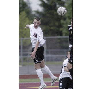 Central Kitsap senior Adam Cronin (15) goes up for a header during a game against Lincoln in 2008. Cronin is a starting forward/midfielder on the 2009 Cougar squad