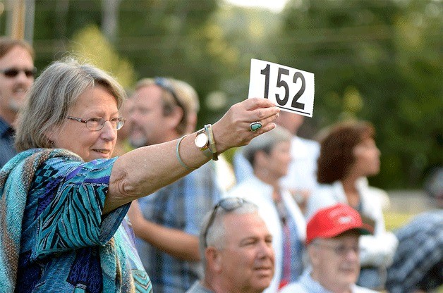 An attendee bids for pie at the 2014 Pie in the Park auction.