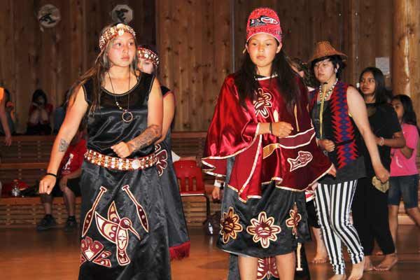 Members of the Nisqually Tribe participate in a paddle dance during protocol