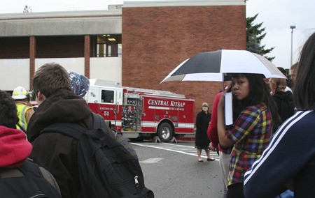 Central Kitsap High School students wait outside Wednesday after Central Kitsap Fire and Rescue crews respond to a reported fire in a girls' bathroom on the third floor.