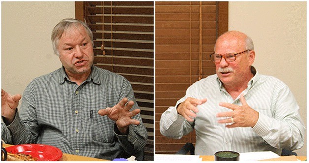 Scott Henden and Glen Robbins talk at a community advisory meeting with the North Kitsap Herald.