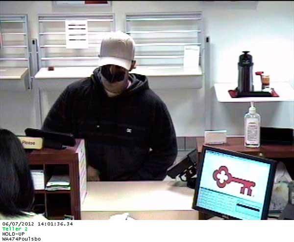The suspect who allegedly robbed Key Bank in Poulsbo was caught on a surveillance camera June 7. The suspect remains at-large.