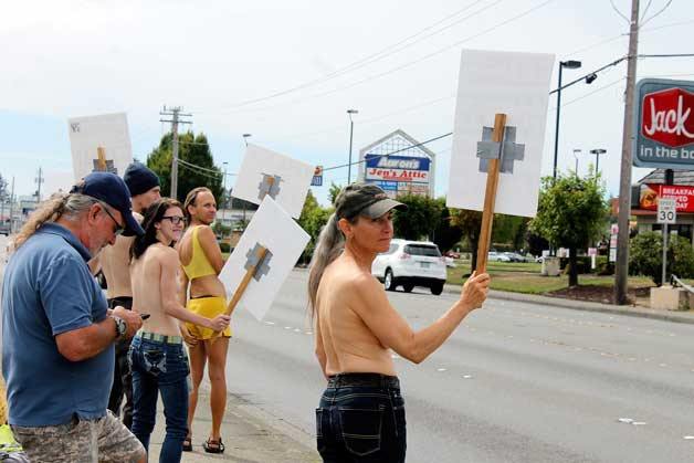 People participate in the equal topless rights protest on Aug. 28 at the corner of Riddell Road and Warren Avenue. The protest was part of the national GoTopless campaign.