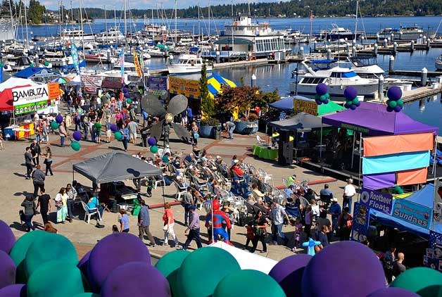People walk near the main stage and food vendors at the Blackberry Festival in Bremerton Sept. 7