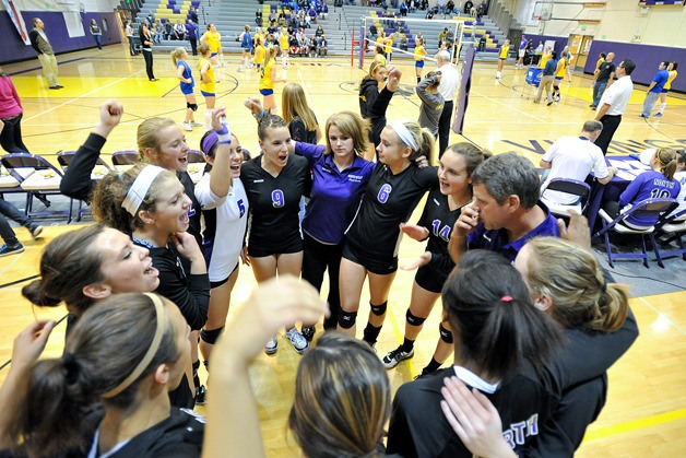 The Viking volleyball team huddles before their match against Sequim High on Oct. 5.