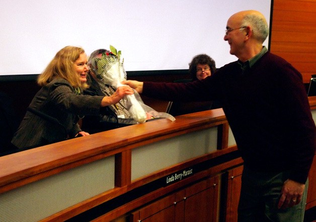 Linda Berry-Maraist is presented with a bouquet of roses from her husband Doug on her last evening as a Poulsbo councilwoman.