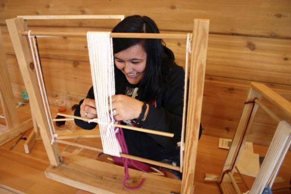 Natalie Fulton of Port Gamble/S'Klallam learns to weave a wool headband at the annual Northwest Native American Basketweavers gathering