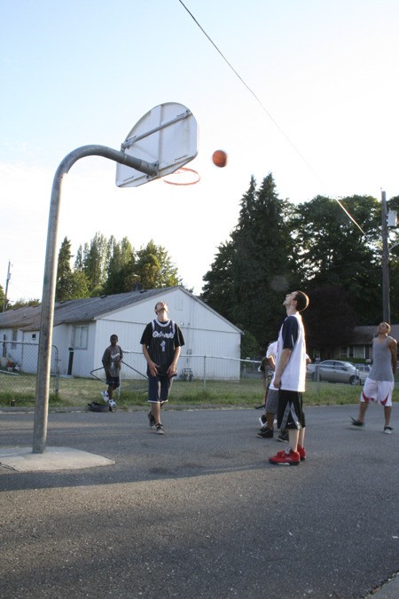 A group of teenagers play a game of basketball Tuesday at Matan Park in Anderson Cove. Residents say that neighbors’ efforts in the past few years to keep the park maintained have helped to make the area safer for children.