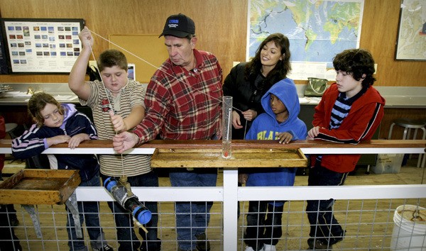 Lab director Ralph St. Andre works with students performing a salinity test at the Poulsbo Marine Science Center
