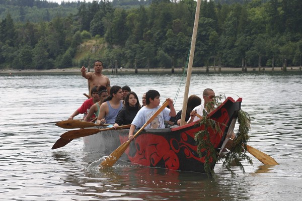 A Queets canoe arrives at Point Julia during the 2011 Canoe Journey.