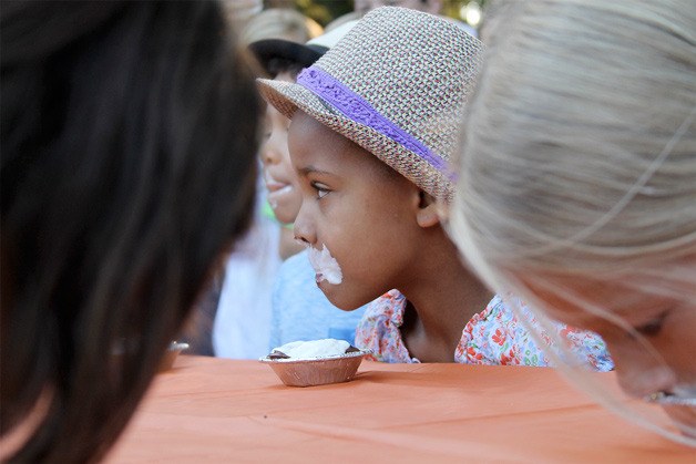 Youngsters compete in a pie eating contest at the Pie in the Park fundraiser in Kingston.