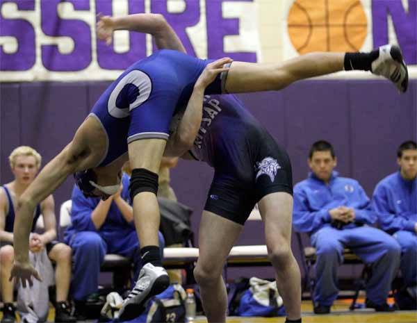 North Kitsap’s Jake Velarde tosses Olympic’s Avery Acsalle to the mat during Wednesday’s night wrestling meet in the North Kitsap High School Gymnasium.
