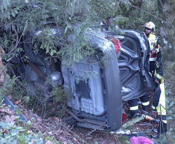 A South Kitsap Fire and Rescue crew examine a vehicle that left the roadway while traveling eastbound on State Route 16